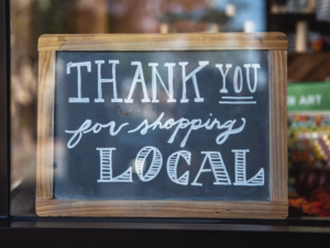 Sign in a shop window that says, "thank you for shopping local."